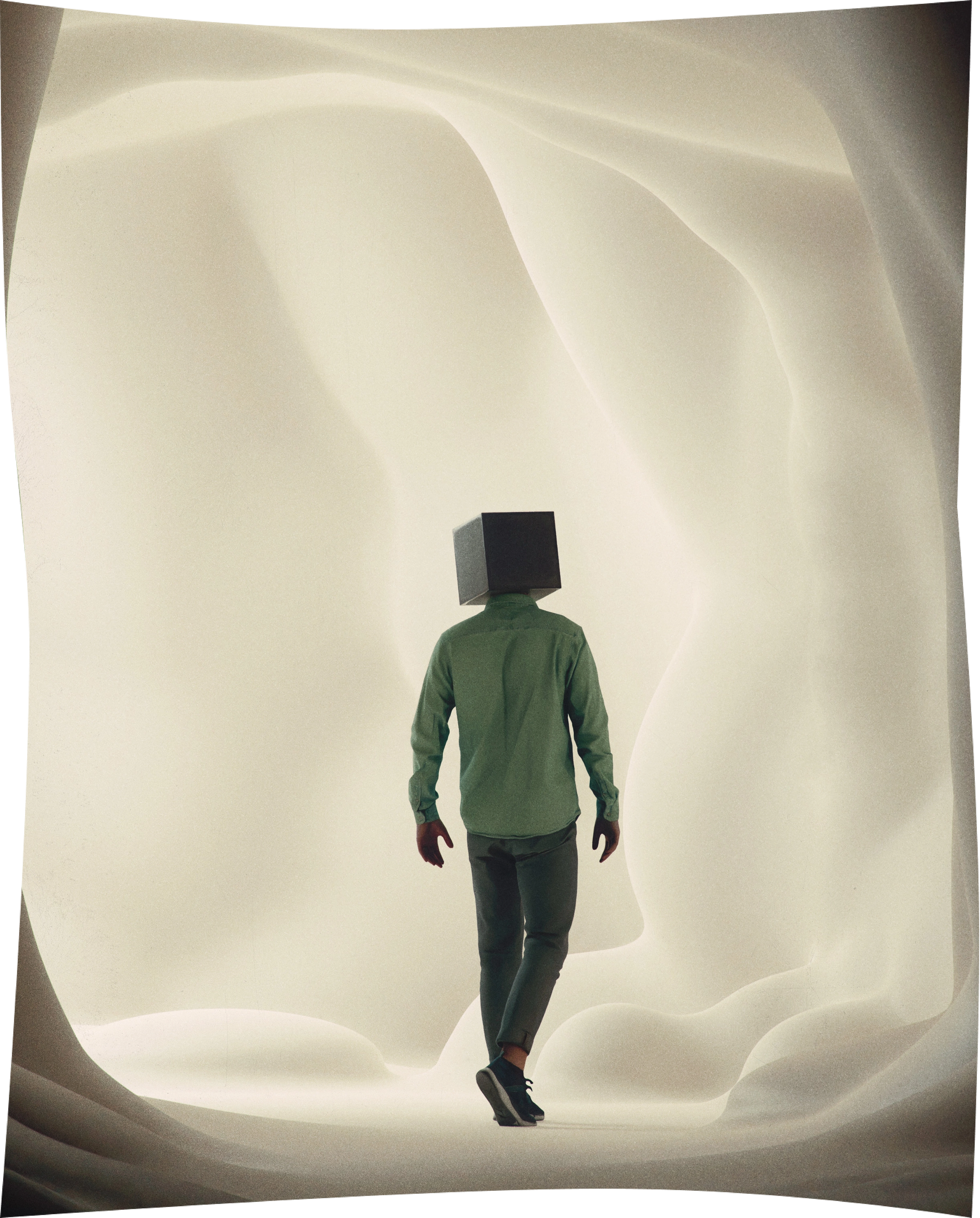 A man with a box covring his face standing in a white quite place